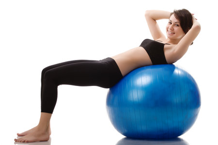 Young, fit and beautiful brunette woman in sportswear isolated on grey. Health care, diet, sport and fitness concept.の写真素材