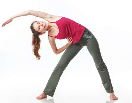 Fitness Workout. Sporty Woman Doing Bicycle Crunch Abs Exercise Lying On Floor Over Pink And Blue Neon Studio Background. Determined Lady Wearing White Fitwear Training Flexing Abdominal Musclesの写真素材