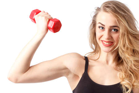 young fitness model posing in studio. Healthy young woman in sportswear standing on grey backgroundの写真素材