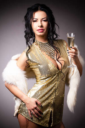 Portrait a beautiful woman in a golden gownの写真素材
