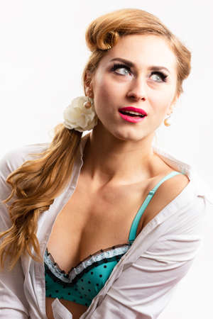 Displeased pin up woman posing with crossed arms on pink backgroundの写真素材