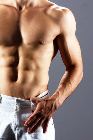pain relief, sport, bodybuilding, strength and people concept - young man standing over black backgroundの写真素材
