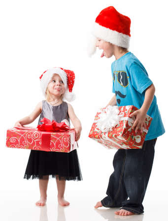 Children charity. school boy and girl in Santa Clause hats. Charity with donate box. Delivery and donation concept. Happy Xmas and New Year holiday. Christmas gifts.の写真素材