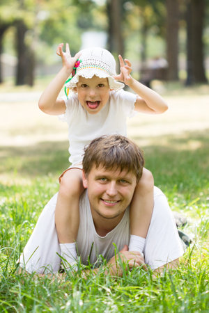 Cute little girl lying on grassの写真素材
