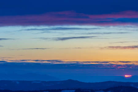 Dramatic sunset sky with clouds. Dramatic sunset over the seaの写真素材