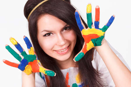 young woman with hands painted with colorful paints, ready for handprints.の写真素材