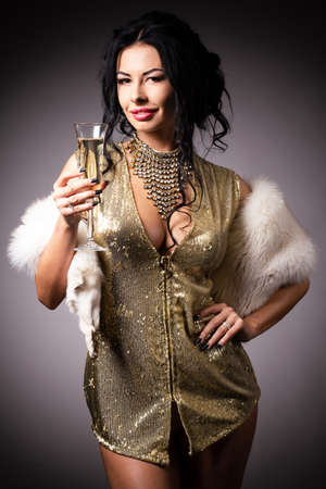 Portrait a beautiful woman in a golden gownの写真素材