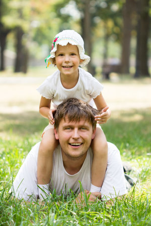Cute little girl lying on grassの写真素材