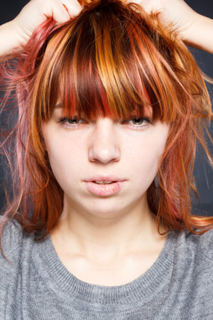Beautiful redhead woman wearing casual t-shirt standing over isolated white background stressed with hand on head, shocked with shame and surprise face, angry and frustrated. Fear and upsetの写真素材