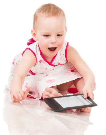 Little girl playing with a digital tabletの写真素材