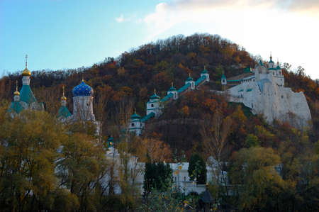 Monastery and church. Aumnal colored foliage of oak tree. Ukraine. National parkの写真素材