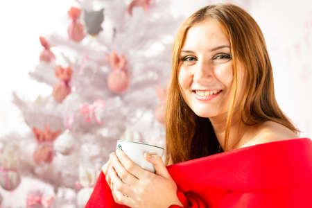 Attractive Christmas girl in a sexual lingerie. Naked body. Seasonal christmas holidays sale discounts. Woman in a sexy Santa Claus costume decorate the Christmas treeの写真素材
