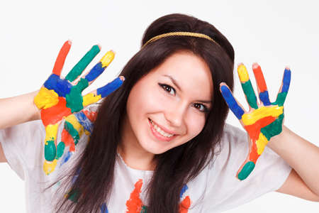 young woman with hands painted with colorful paints, ready for handprints.の写真素材