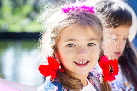 Happy laughing girl on grass. Smiling child outdoors