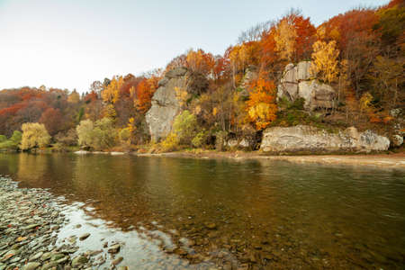 View of the waterfall in autumn. Waterfall in autumn colors. Mountain river in the autumn landscape. Ukraine, river Stryj.の写真素材