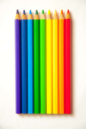 Background of color pencils in a variety of colors and a sharpener.の写真素材