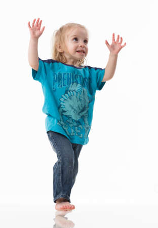 Cheerful little girl gesticulating. The concept of a holiday, emotions and psychology. Isolated on white background.の写真素材