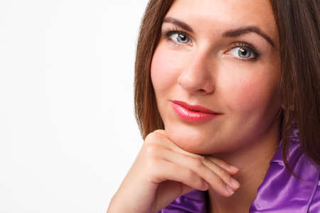 Young beautiful brunette woman in purple dress, isolated on white backgroundの写真素材
