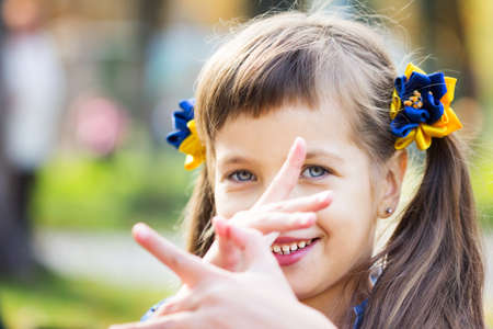 Happy laughing girl on grass. Smiling child outdoorsの写真素材