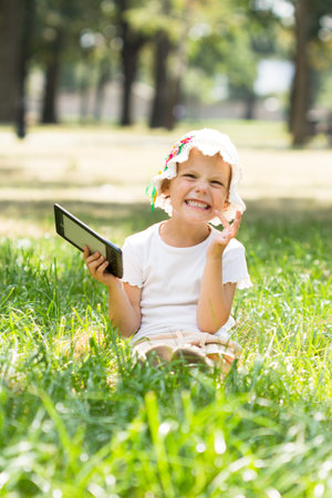 Cute little girl lying on grassの写真素材