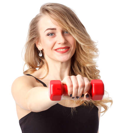 young fitness model posing in studio. Healthy young woman in sportswear standing on grey backgroundの写真素材