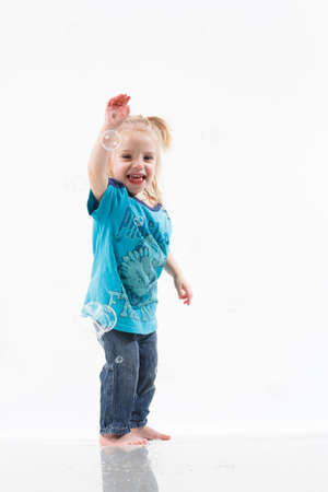 Cheerful little girl gesticulating. The concept of a holiday, emotions and psychology. Isolated on white background.の写真素材