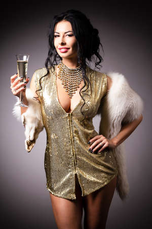Portrait a beautiful woman in a golden gownの写真素材