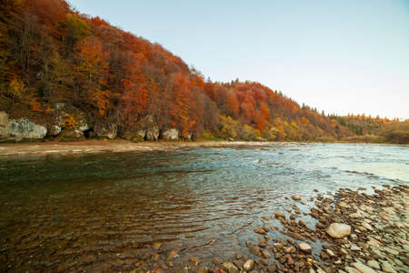 View of the waterfall in autumn. Waterfall in autumn colors. Mountain river in the autumn landscape. Ukraine, river Stryj.の写真素材