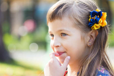 Happy laughing girl on grass. Smiling child outdoorsの写真素材