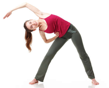 Fitness Workout. Sporty Woman Doing Bicycle Crunch Abs Exercise Lying On Floor Over Pink And Blue Neon Studio Background. Determined Lady Wearing White Fitwear Training Flexing Abdominal Musclesの写真素材