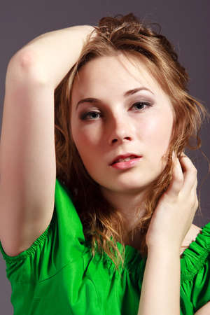 beautiful young girl in a short green dress and black stockingsの写真素材