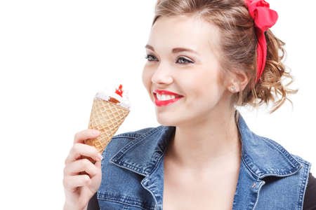 Young caucasian woman eating sweet cupcake over isolated background happy with big smile doing ok sign, thumb up with fingers, excellent signの写真素材