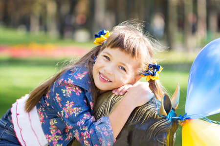 Happy laughing girl on grass. Smiling child outdoorsの写真素材