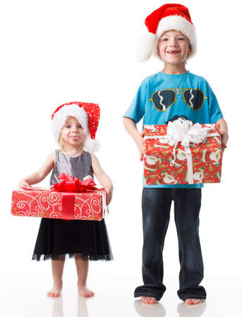 Children charity. school boy and girl in Santa Clause hats. Charity with donate box. Delivery and donation concept. Happy Xmas and New Year holiday. Christmas gifts.の写真素材