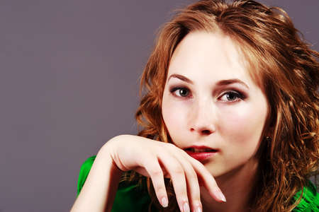 beautiful young girl in a short green dress and black stockingsの写真素材