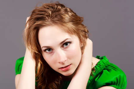 beautiful young girl in a short green dress and black stockingsの写真素材