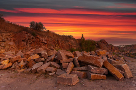 A desert landscape with rocks and huge stones in the foreground, taken in a granite quarry in Ukraine.の写真素材