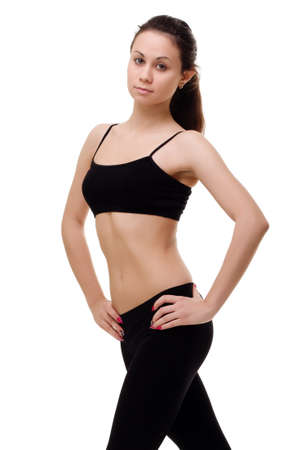 Young, fit and beautiful brunette woman in sportswear isolated on grey. Health care, diet, sport and fitness concept.の写真素材