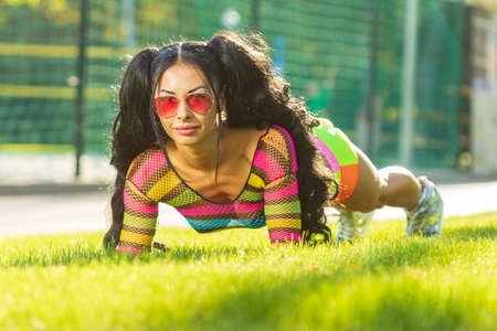 Active lifestyle. Fitness woman exercising outdoorsの写真素材