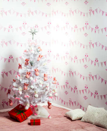 Attractive Christmas girl in a sexual lingerie. Naked body. Seasonal christmas holidays sale discounts. Woman in a sexy Santa Claus costume decorate the Christmas treeの写真素材