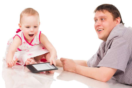 Little girl playing with a digital tabletの写真素材