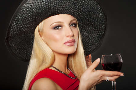 Beautiful Young Caucasian Woman, In Her Twenties, With Blonde Hair, Wearing Sexy Black Lingerie And Stockings, Isolated On blackの写真素材