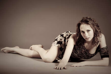 beautiful young girl in a short green dress and black stockingsの写真素材
