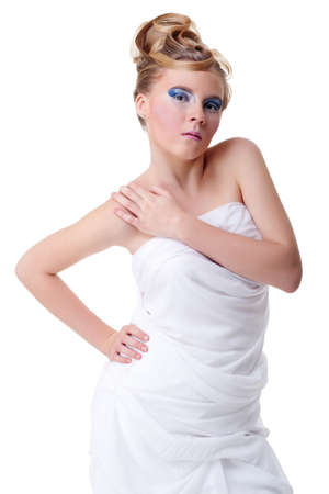 The girl with long hair in a light, white dress posing on light grey background. Studio shot,isolated image.の写真素材