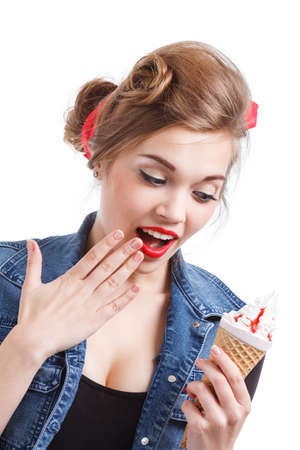 Young caucasian woman eating sweet cupcake over isolated background happy with big smile doing ok sign, thumb up with fingers, excellent signの写真素材