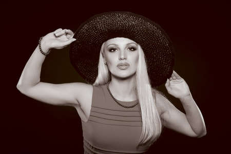 Beautiful Young Caucasian Woman, In Her Twenties, With Blonde Hair, Wearing Sexy Black Lingerie And Stockings, Isolated On blackの写真素材