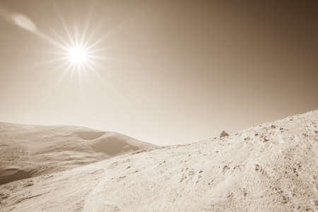 Snow covered fir trees on the background of mountain peaks. Panoramic view of the picturesque snowy winter landscape.の写真素材