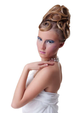 The girl with long hair in a light, white dress posing on light grey background. Studio shot,isolated image.の写真素材
