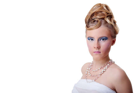 The girl with long hair in a light, white dress posing on light grey background. Studio shot,isolated image.の写真素材