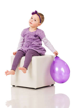 Little girl playing with a balloonの写真素材
